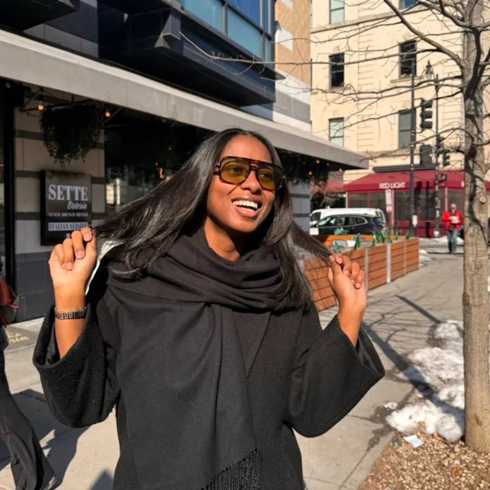 Faben Henok smiling outdoors with long smooth hair after a Katty Hair Studio visit