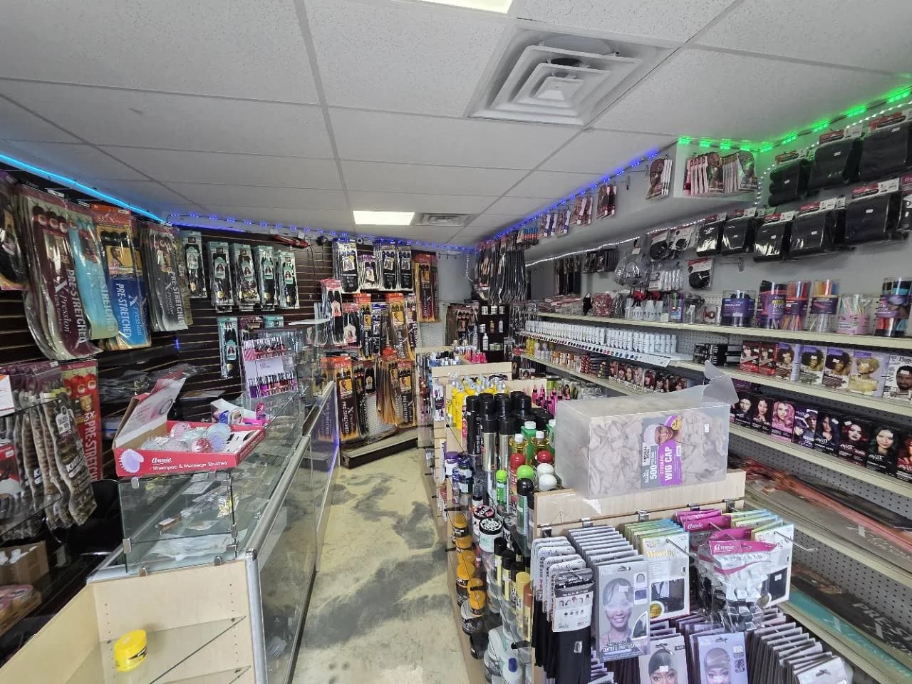 Beauty supply area inside Katty Hair Studio stocked with shampoos, conditioners, hair dyes, extension hair, styling products, tools, and accessories