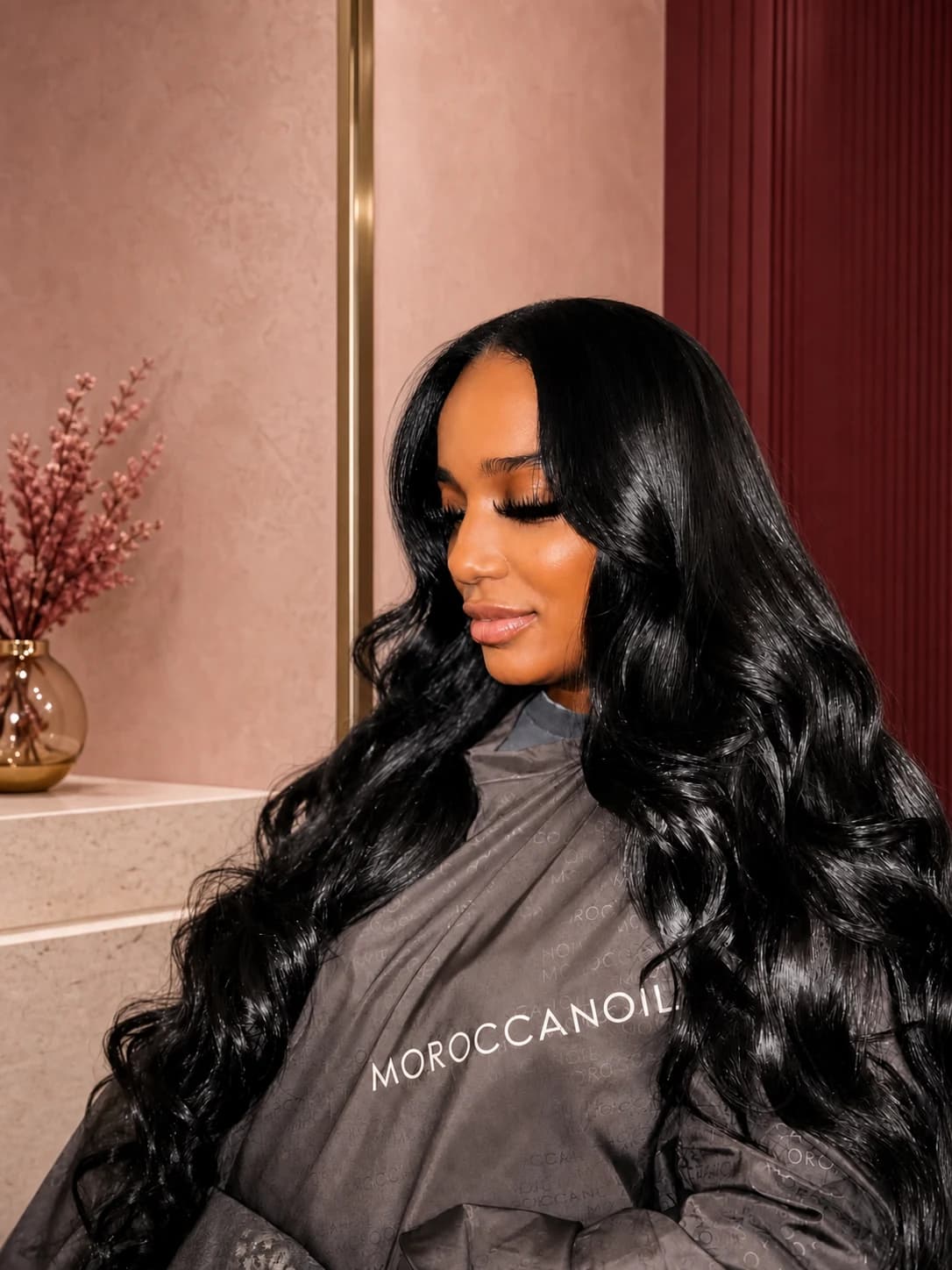 Client with long glossy black body waves styled by Katty Hair Studio